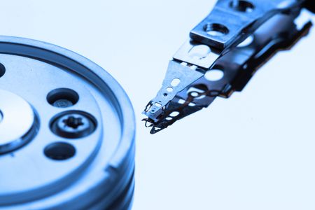 Opened hard disk drive colose-up toned in blue color