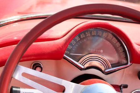 Speedometer and wheel of classic red car cloose-upの写真素材