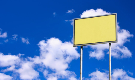 Blank yellow sign against deep blue sky backgroundの写真素材