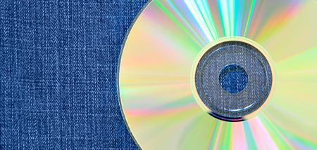 Raibow compact disk over blue jean backgroundの写真素材