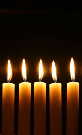 Five burning candles over black backgroundの写真素材
