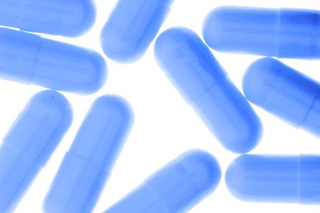 Blue capsules isolated over white background