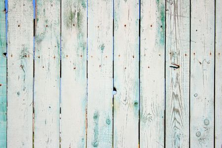 Old painted wooden fence close-up, may be used as backgroundの写真素材