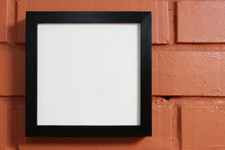 Blank frame over red bricks wall close-upの写真素材