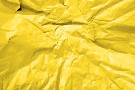 Crumpled deep yellow paper, may be used as backgroundの写真素材