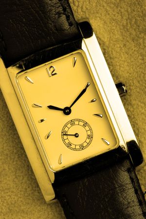 Face of watch close-up over leather background