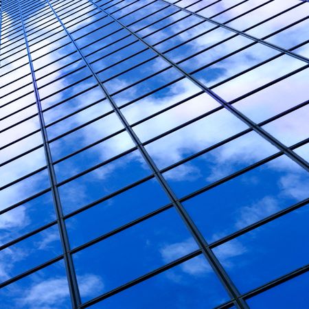 Glass wall of business center and sky reflection, may be used as background