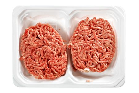 Raw meat rissoles in tray isolated over white background