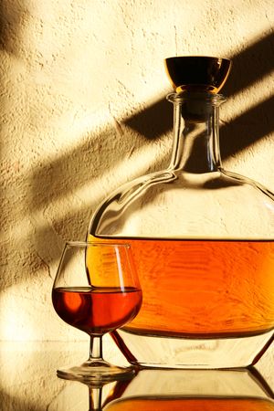 Brandy sniffer glass and bottle close up