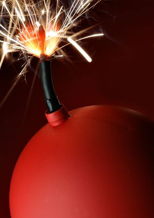 Red bomb with burning fuse close-up