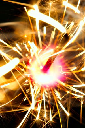 Sparkler on fire close-up over black backgroundの写真素材