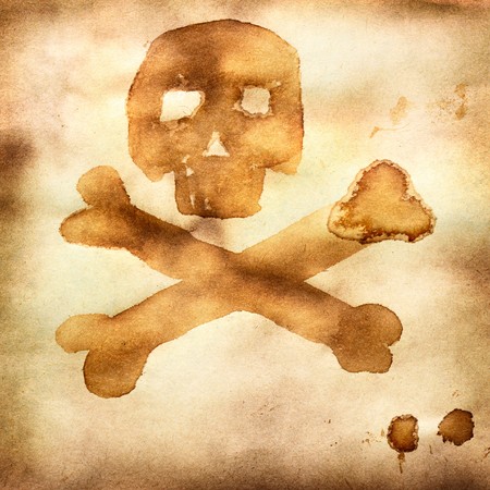 Old paper with print of crossed bones and skullの写真素材