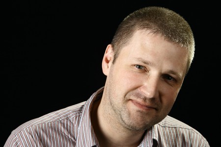 Portrait of the male over black background