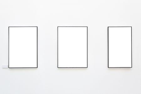 Blank frames on the wall at art galleryの写真素材