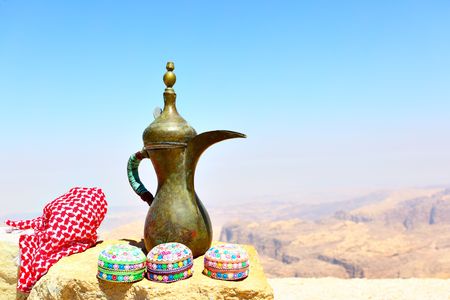 Arabian souvenirs on the stone and Jordan's mountains in the backgroundの写真素材