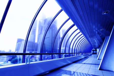 Perspective of the covered bridge and skyscrapers beyond windowの写真素材