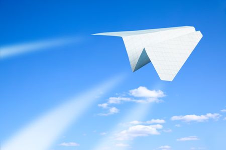 Paper plane flying. Sky and clouds in the background 
の写真素材