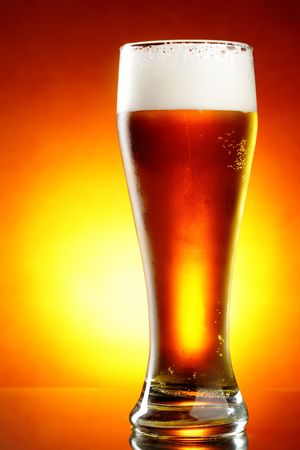 Glass of beer with froth close up の写真素材