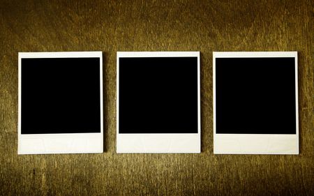 Three old photos over the wood surfaceの写真素材