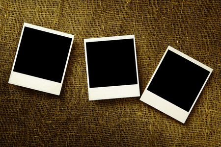 Three old photos over the textile surfaceの写真素材