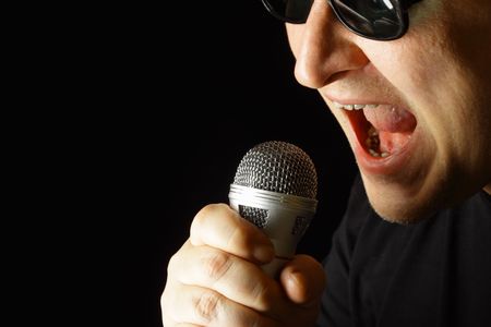 Performer with microphone over black background
の写真素材