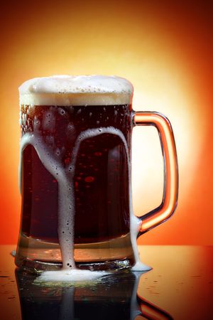 Mug of dark beer with frith close up