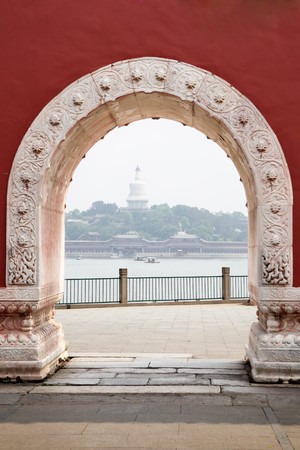 View through gate to Beihai Royal Park in Beijing, Chinaの写真素材