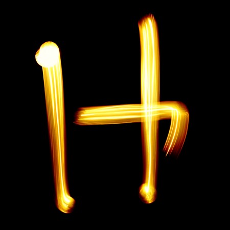 Created by light alphabet over black backgroundの写真素材