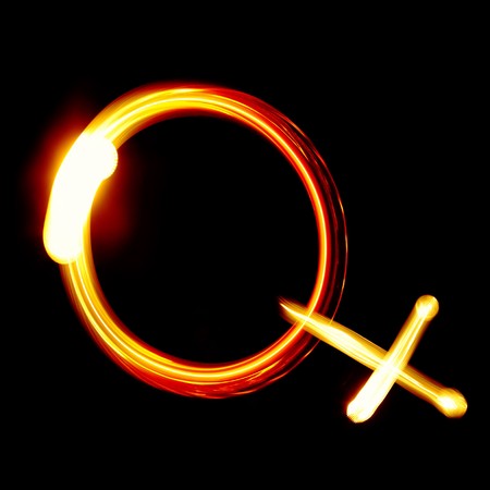 Female symbol created by light over black backgroundの写真素材