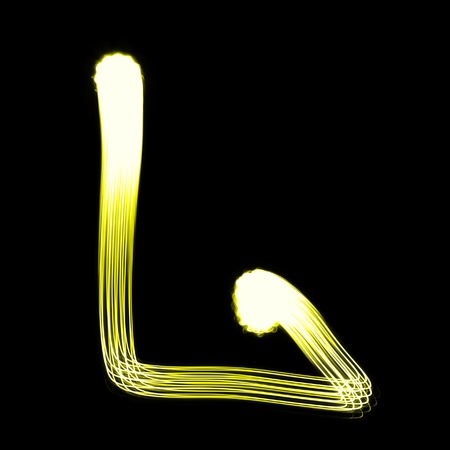 L - Created by light alphabet over black backgroundの写真素材