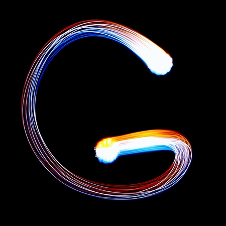 G - Created by light colorful letters over black backgroundの写真素材