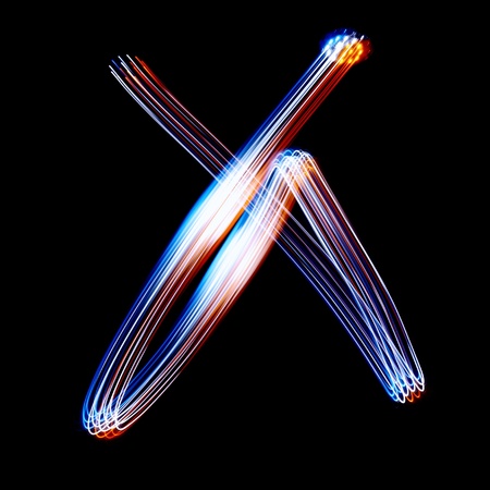 X - Created by light colorful letters over black backgroundの写真素材
