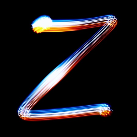 Z - Created by light colorful letters over black backgroundの写真素材