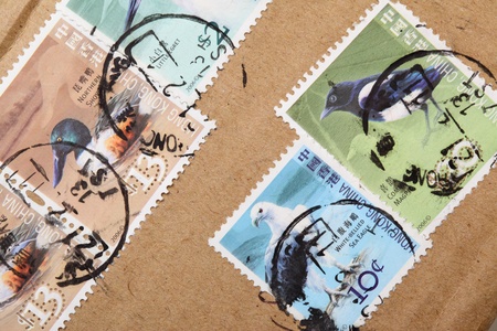 Postage-stamps close-up on postal package wrapperの写真素材
