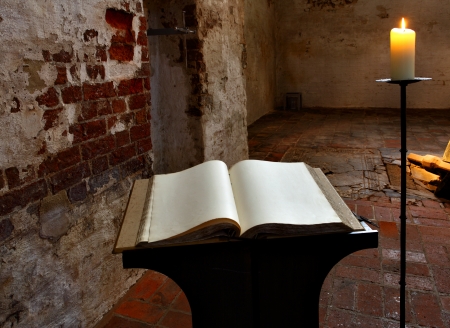 Open book with blank pages and candleの写真素材