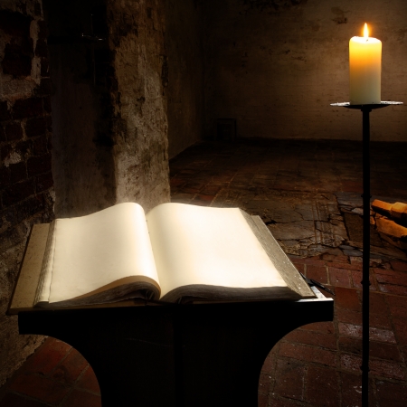 Open book with blank pages and candleの写真素材