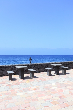Sea front with stone tablesの写真素材