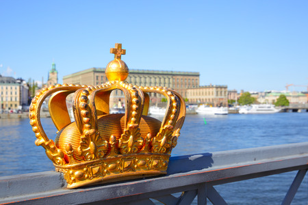 Crown on a bridge railing in Stockholm and Royal Palace in the background Swedenの写真素材