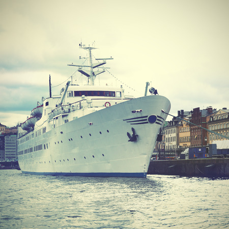 Waterfront in Stockholm Gamla Stan and ship-hotel. Retro style filtred imageの写真素材