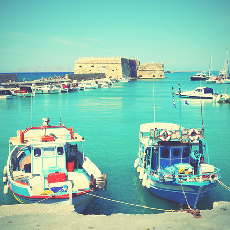 Fishing boats in Heraklion, Crete, Greece. Retro style filtred imageのeditorial素材