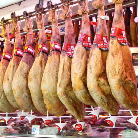 BARCELONA, SPAIN - JUNE 15, 2011: Market stall with spanish ham (Jamon) at La Boqueria market in Barcelona. Shallow DOF!のeditorial素材