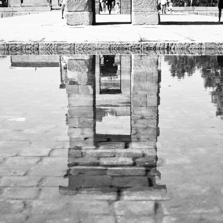 Temple of Debod in Madrid reflects in pond, Spain. Black and white image