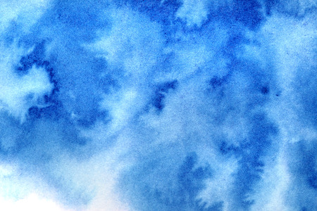 Vivid blue diffused watercolor stains. Abstract textured backgroundの写真素材