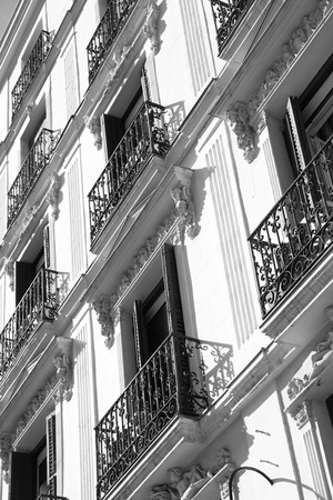 Wall of old building with small balconies in Madrid, Spain. Black and white imageの写真素材