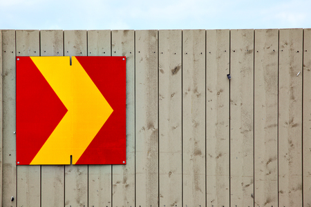 Arrow sign on wooden fence. Copyspace compositionの写真素材
