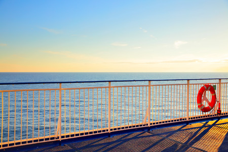 Promenade open deck on a cruise ship at sunset