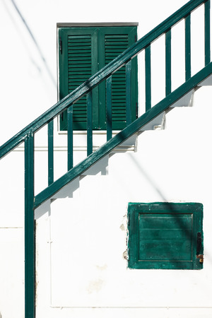 Staircase with railing iof traditional greek whitewashed house in Myconos Island, Greeeceの写真素材