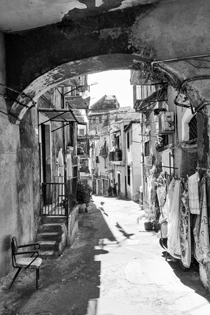 Old street with dilapidated houses in Catania, Sicily, Italy. Black and white imageの写真素材