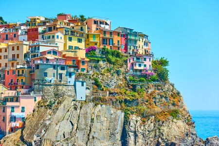 Picturesque houses on the rocky coast in Manarola - a small town in Cinque Terre, La Spezia, Italy