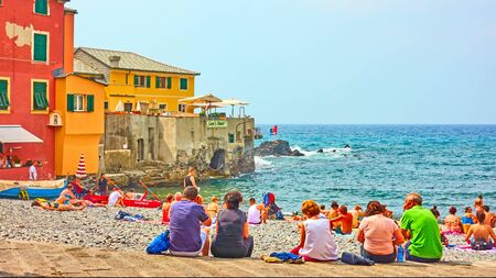 Genoa, Italy - July 7, 2019: People by the sea on Boccadasse beach in Genoa, Liguria
